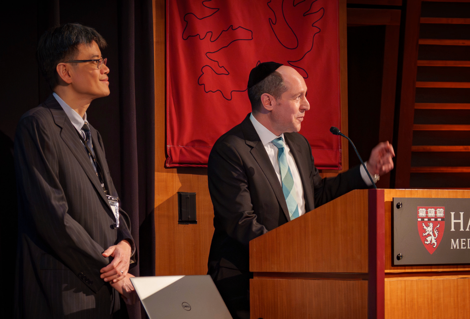 Summit leaders speaking from the Harvard Medical School podium