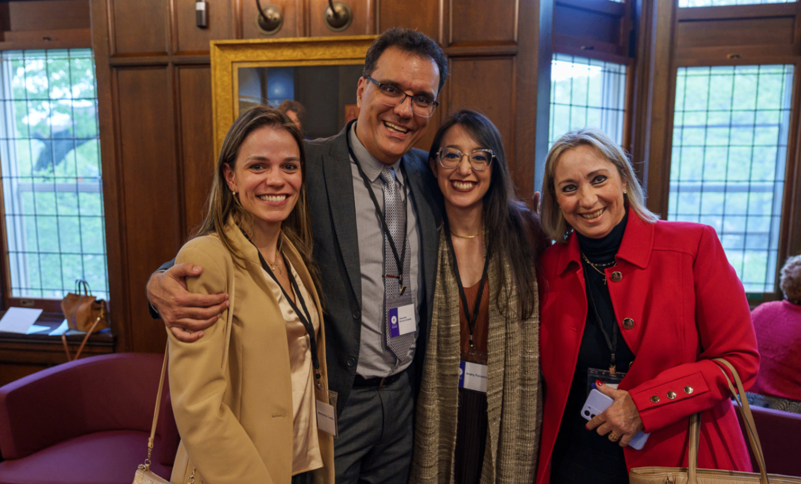 Global Summit attendees gathered together in a wood-paneled venue