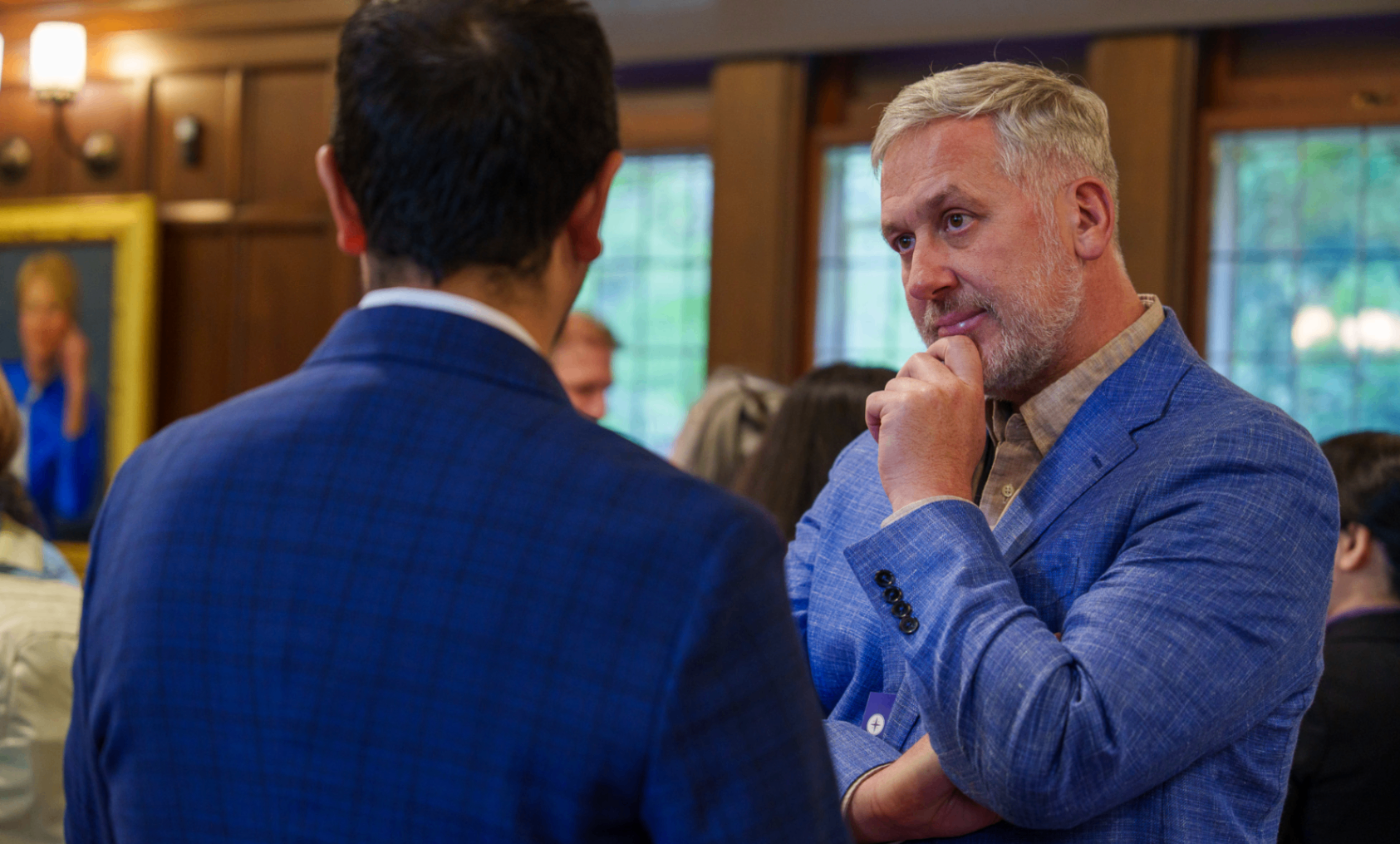Summit attendee in conversation during a networking moment
