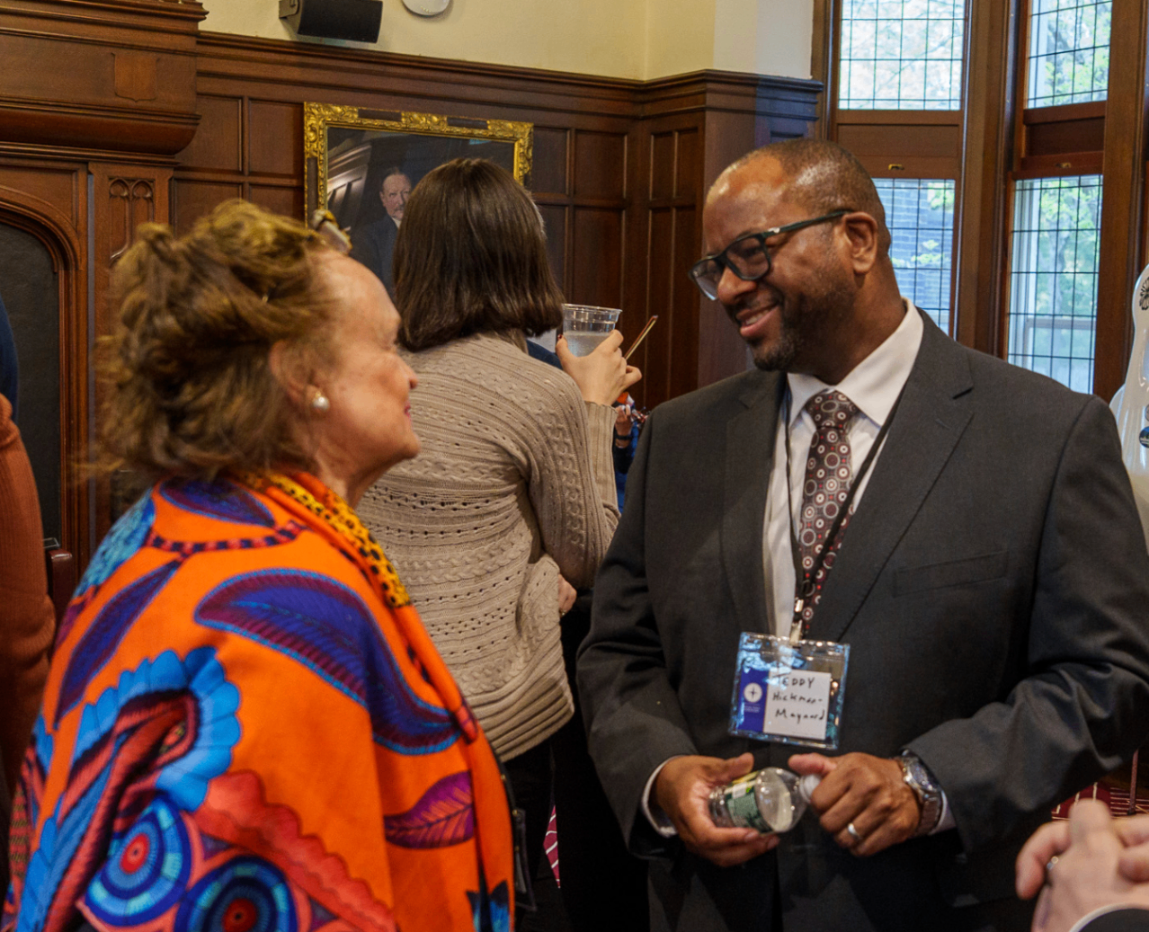 Two attendees speaking during a summit reception