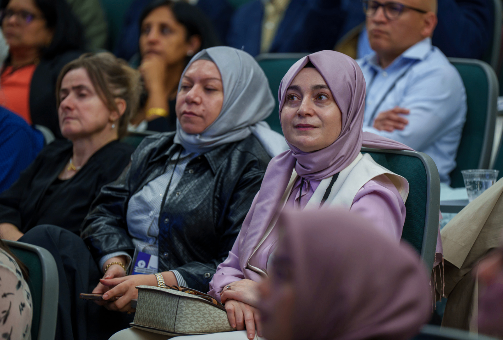 Audience members listening during a summit session